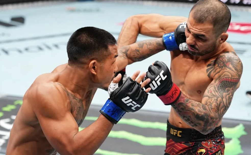 Two fighters trade strikes in the Octagon at UFC 331 in Los Angeles